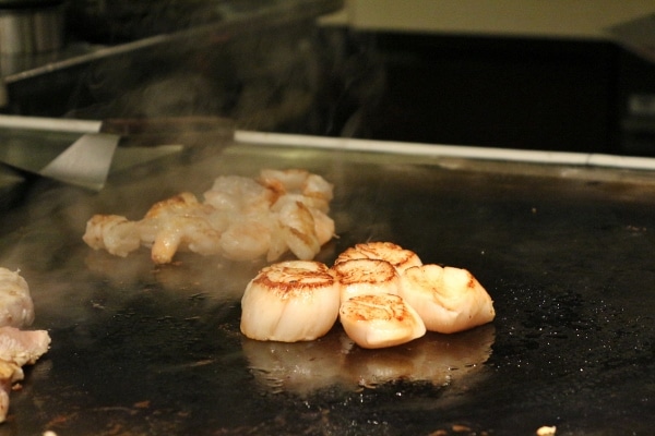 scallops and shrimp cooking on a hot surface