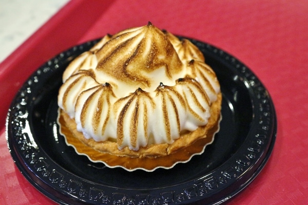 a small meringue topped tart on a plate