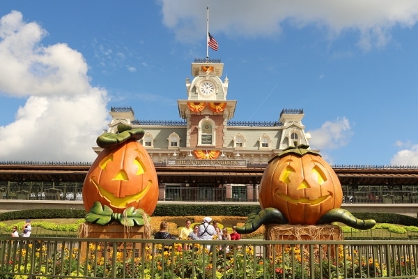 two large jack-o-lantern decorations at entrance to Disney\'s Magic Kingdom