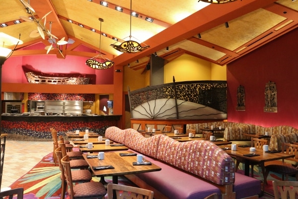 long banquette seating with tables and chairs inside Kona Cafe dining room