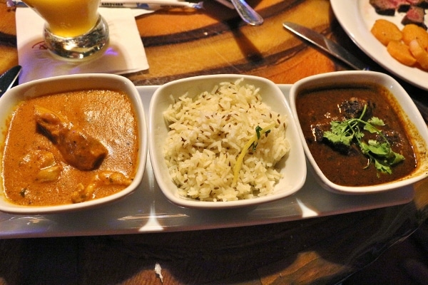 white bowls filled with rice and two different kinds of curry