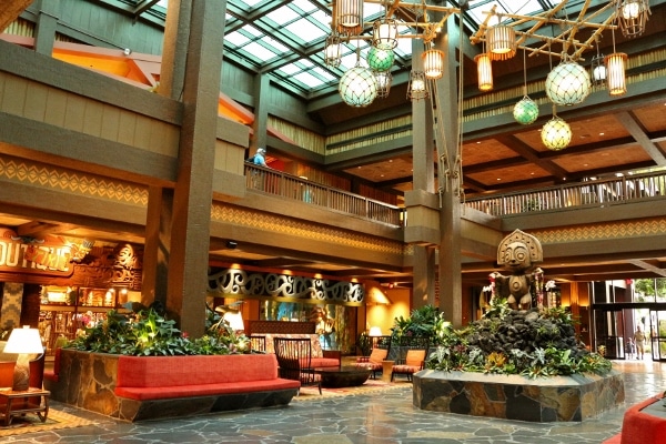 seating areas inside the Polynesian resort lobby with bright skylights and wooden decorations