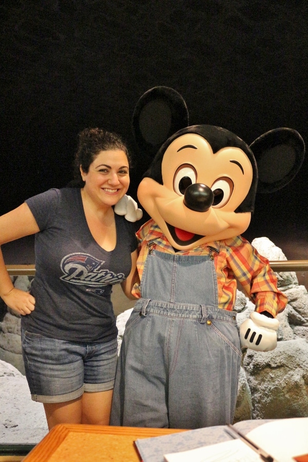 A woman posing with Farmer Mickey