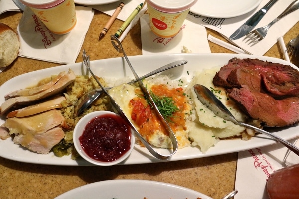 a platter of various proteins and side dishes served family style