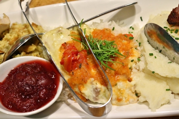 fish with an orange sauce served with white rice on a platter