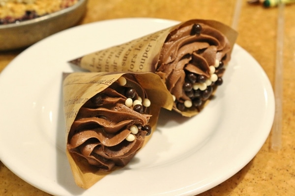 two cupcakes served in paper cones