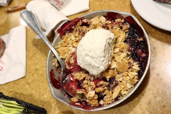 a fruit skillet topped with a crumb topping and whipped cream