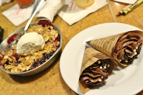 a fruit skillet and cone cupcakes on a table