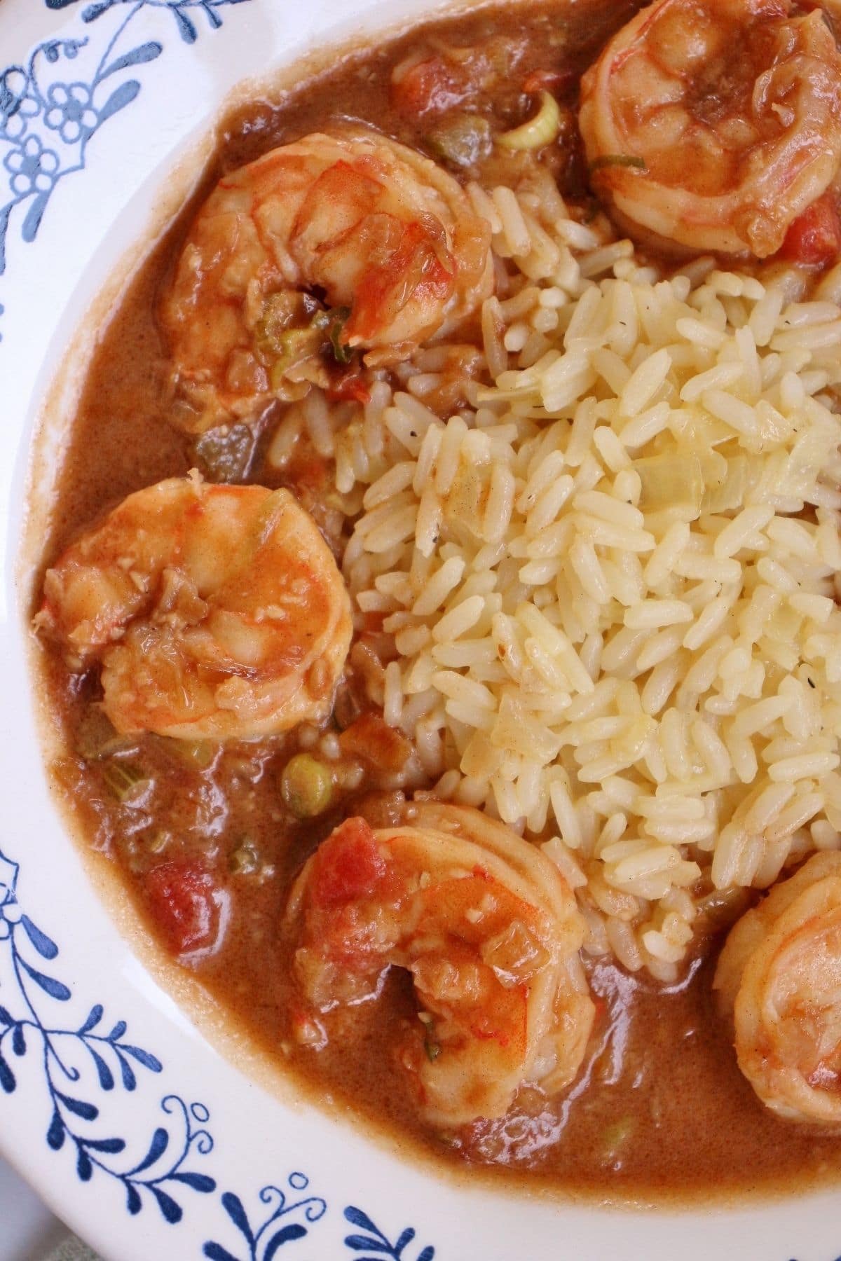 overhead closeup of a shallow bowl of white rice surrounded by creamy shrimp etouffee