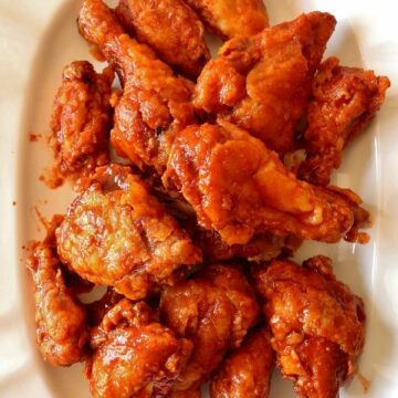 overhead view of a large white platter of Korean fried chicken