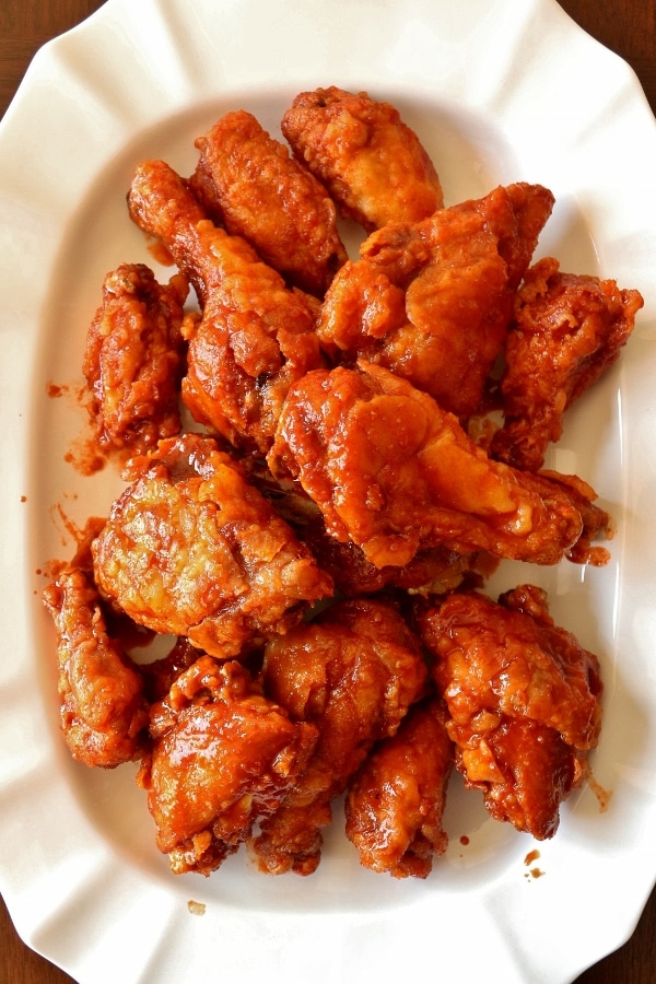 overhead view of a large white platter of Korean fried chicken