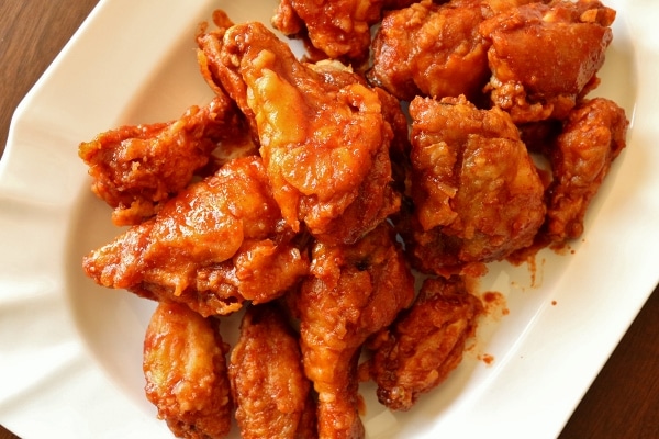 a large platter of Korean fried chicken piled high