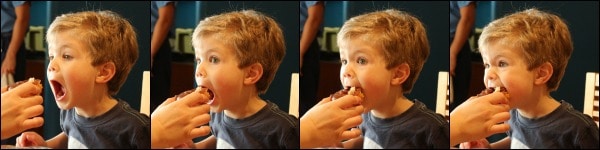 A young boy eating a doughnut
