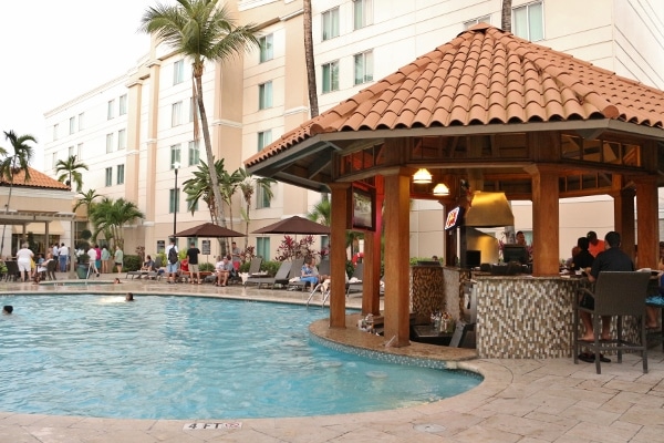 an outdoor swimming pool with a small bar and grill next to it