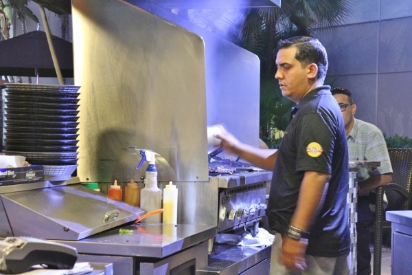 A person standing in a kitchen preparing food