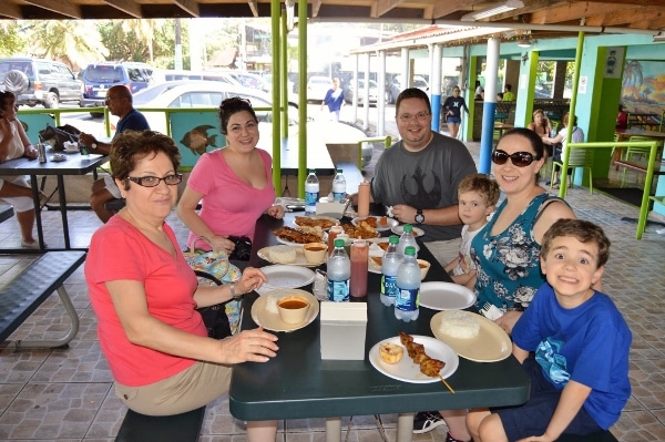 A group of people sitting at a table eating Puerto Rican food