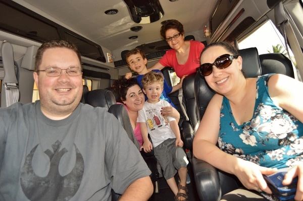 A group of people posing for the camera inside a van