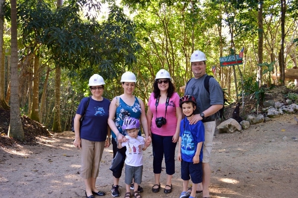 A group of people wearing helmets posing outside