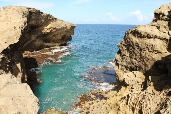 a view of water between a rocky landscape