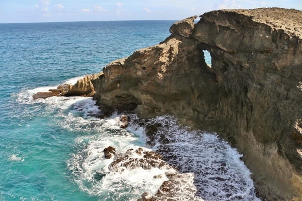 a rocky area next to a body of water