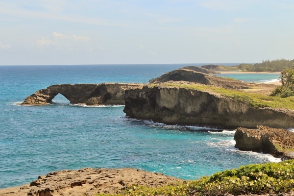 rocky arches in the distance along a shore