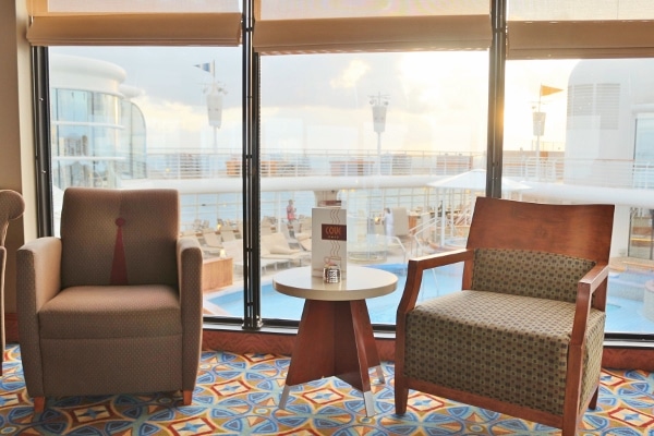 a seating area overlooking the pool deck in the Outlook Cafe