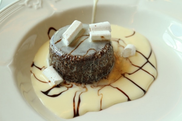 a hot chocolate fudge pudding cake with vanilla sauce on a plate