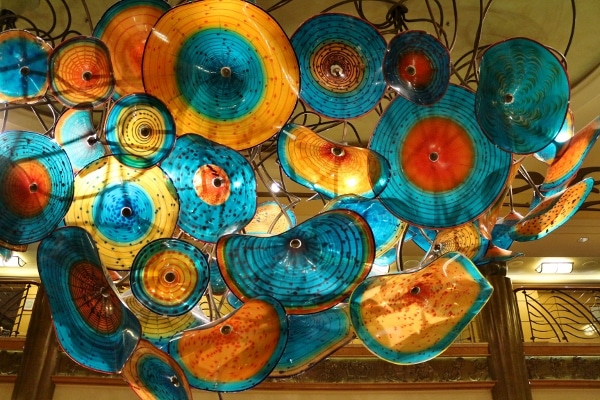 the colorful glass chandelier inside the lobby atrium of the Disney Wonder cruise ship