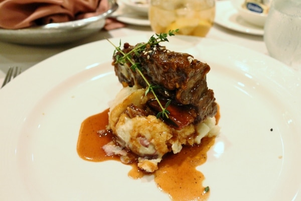 braised short ribs served over a pile of mashed potatoes