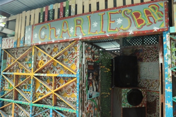 a colorful sign that says Charlie\'s Bar