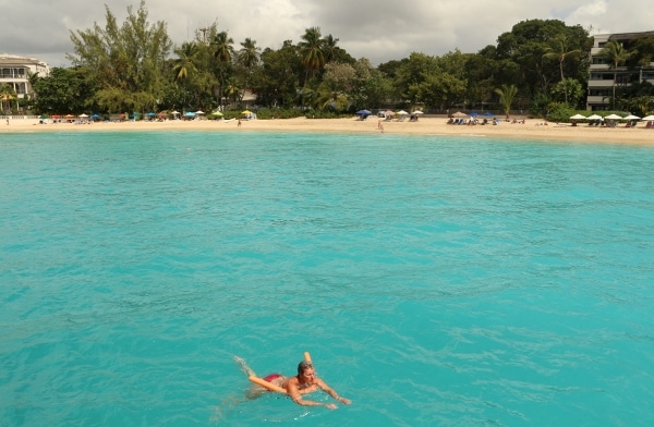 a woman swimming in turquoise blue Caribbean water