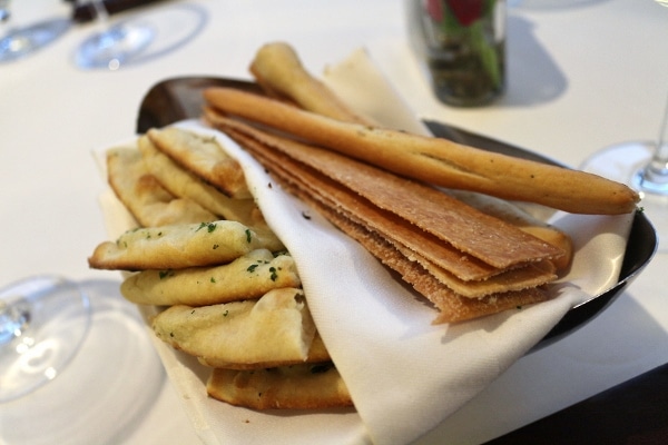 A bread plate with a variety of crackers and flatbreads