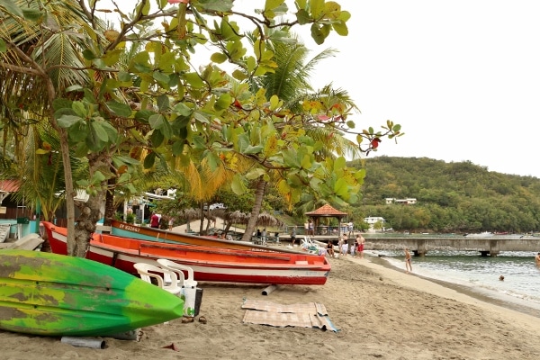 A boat sitting on top of a sandy beach