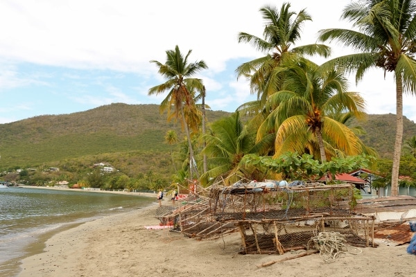 small shellfish cages on the shore of a tropical beach