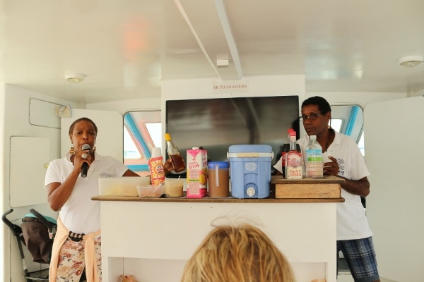 two people on either side of a small boat bar