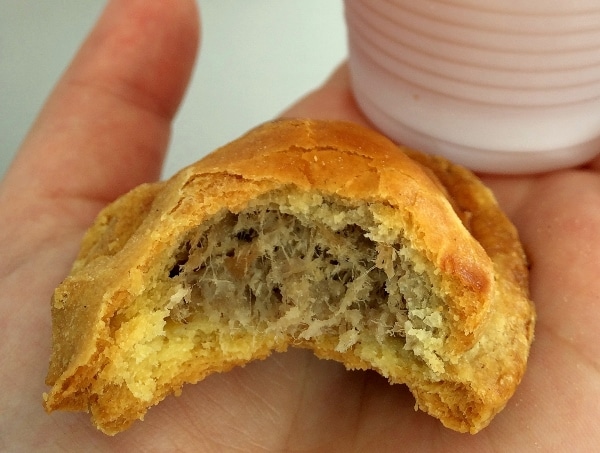 A close up of a half-eaten savory pastry