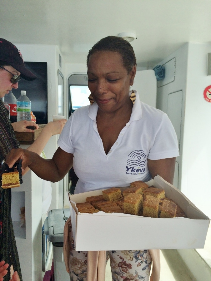 a woman holding a box of cake squares