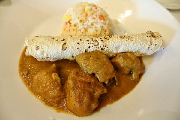 A plate of chicken curry with rice