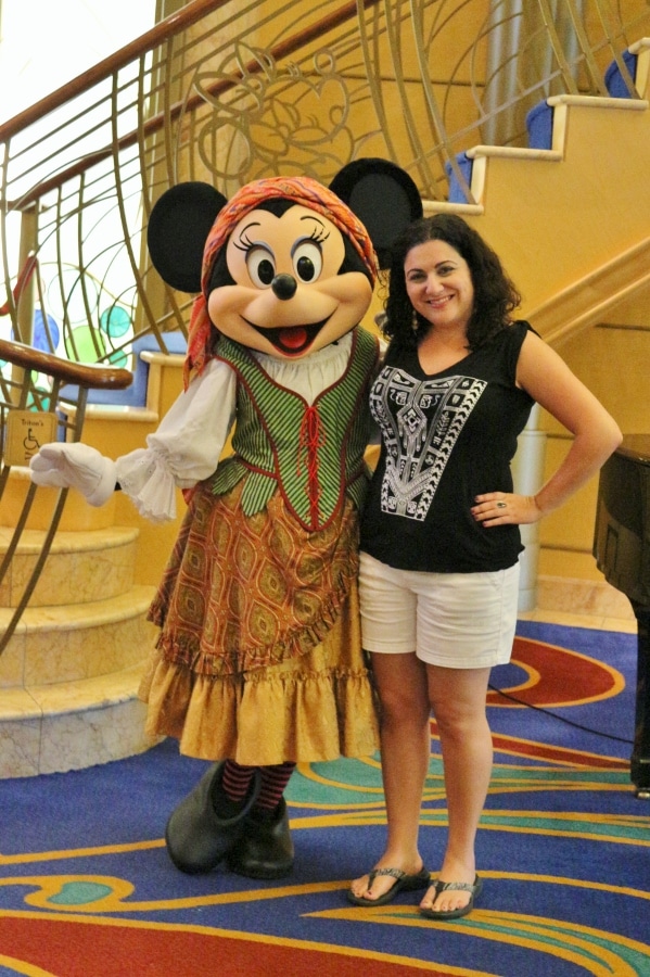 a woman posing with Minnie Mouse dressed as a pirate