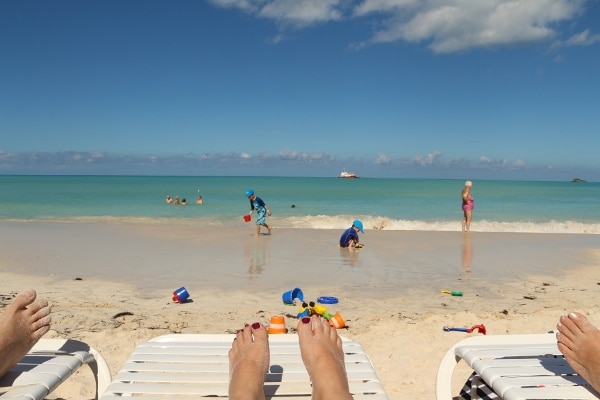 view from a beach chair of people on a beach