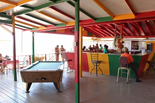 a covered area with a bar and pool table