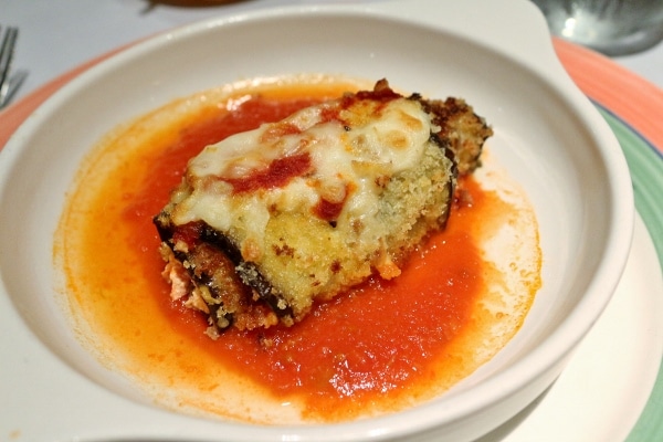 an eggplant rollatini with cheese and tomato sauce in a small dish