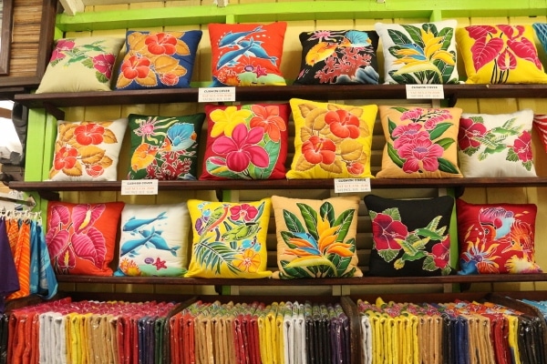colorful tropical pillows arranged in a store