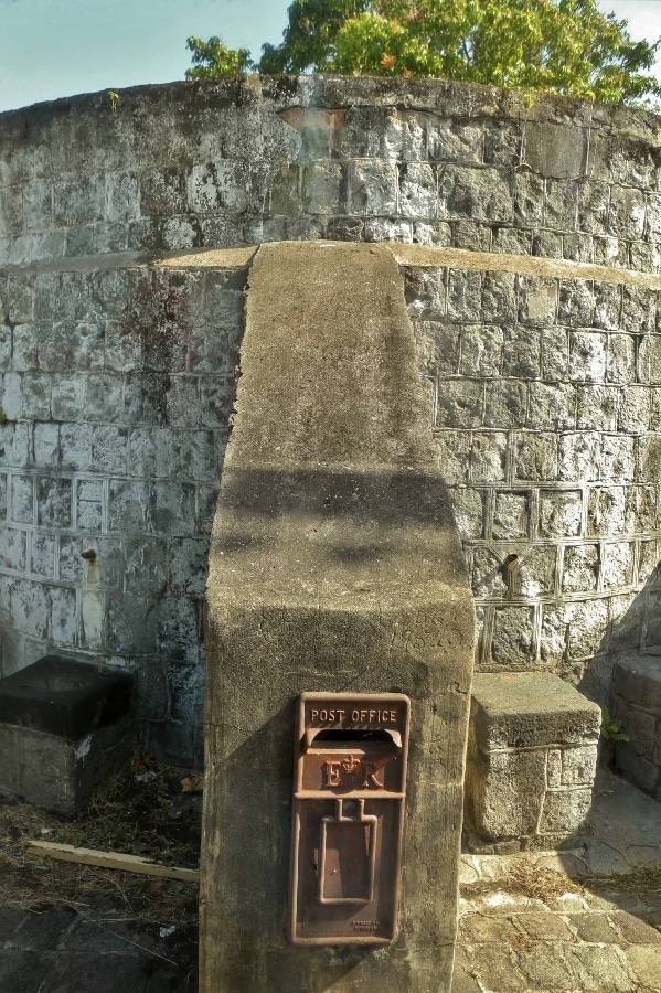 an old post office box on a stone structure