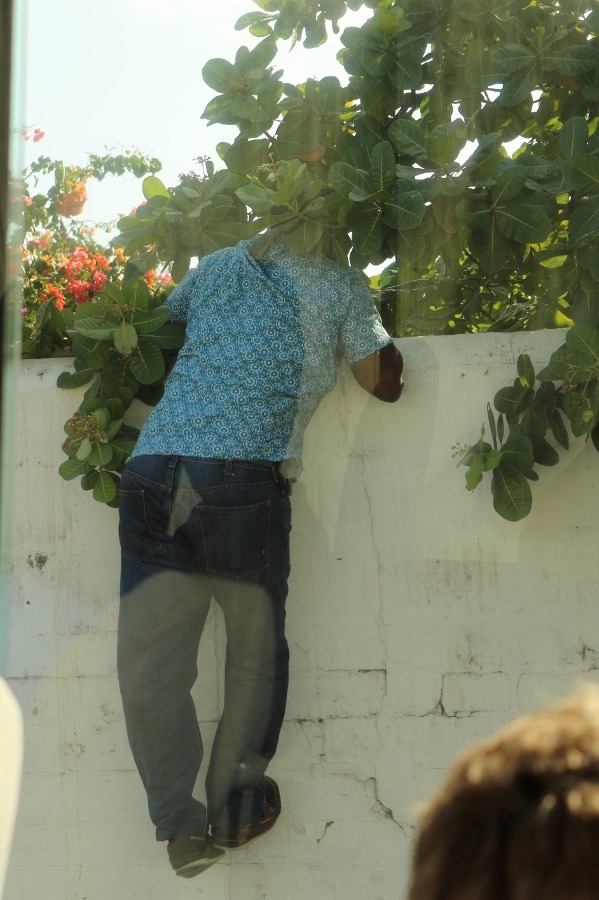 a man climbing onto a wall