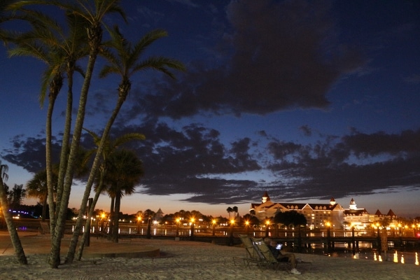 view of Disney\'s Grand Floridian Resort from a nearby beach at night