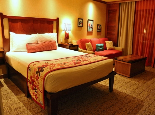 A hotel bedroom with a bed and sitting area