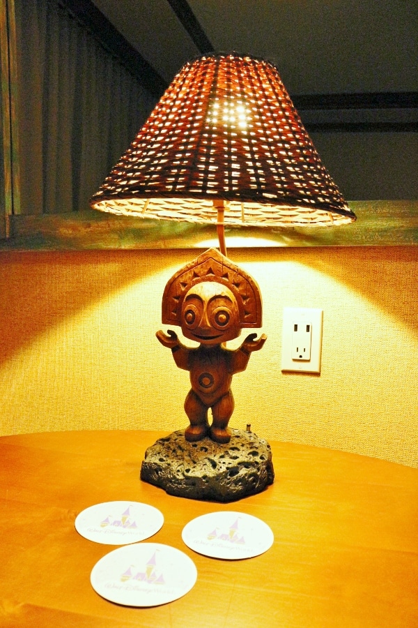 A tiki style lamp that is sitting on a table