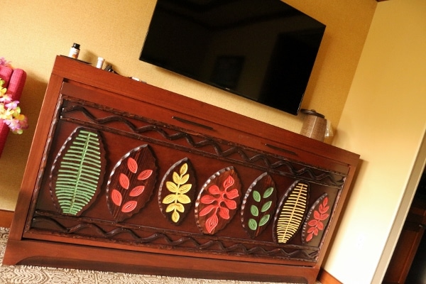 A close up a closed Murphy bed with a television hanging over it on the wall