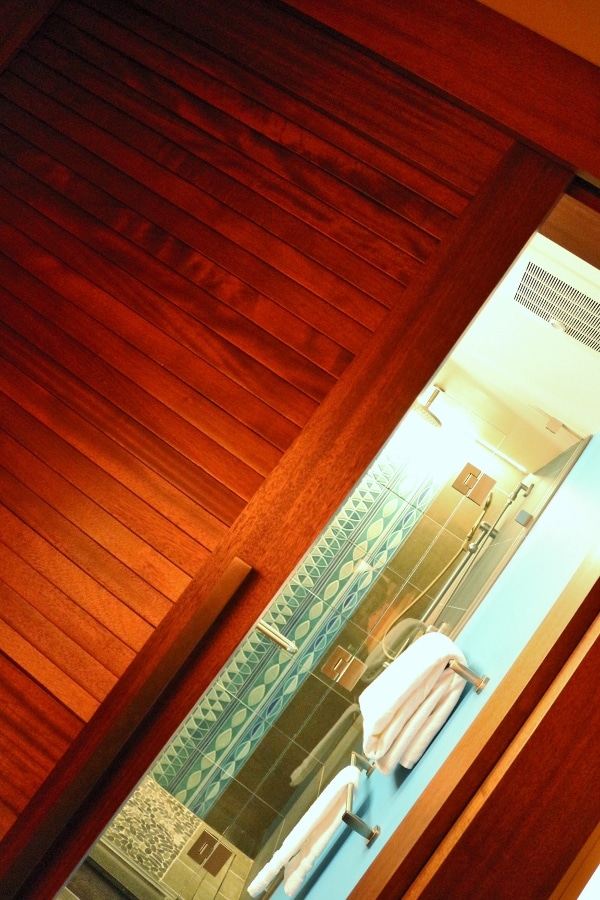 A close up of a wood sliding bathroom door